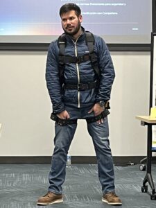 Eduardo Cortez, Falltech, demonstrates the correct fit for a fall protection body harness. 