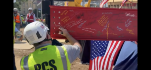 Jeff Psencik signs final structural beam at alamo