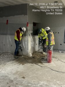A BCS work crew chips concrete with hammer drills using respiratory protection and
water to control respirable crystalline silica dust inside the Central Market on Broadway.
